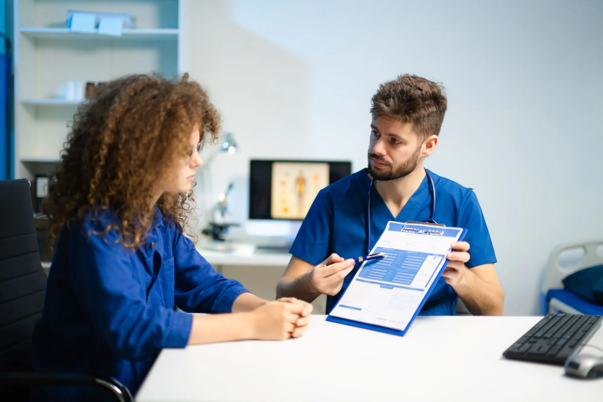 Two members of the practice team reviewing a patient file