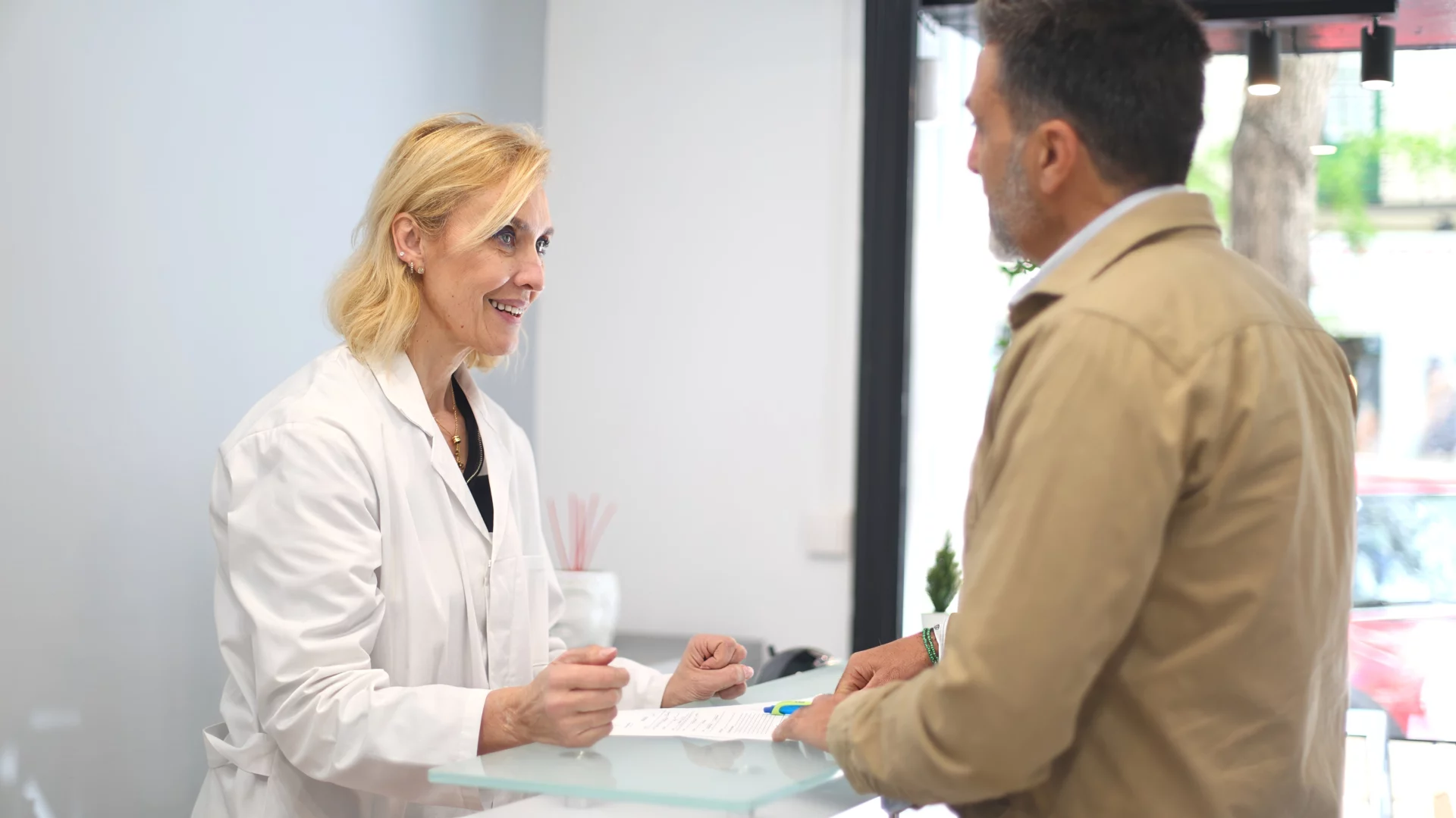 A patient paying by card at reception
