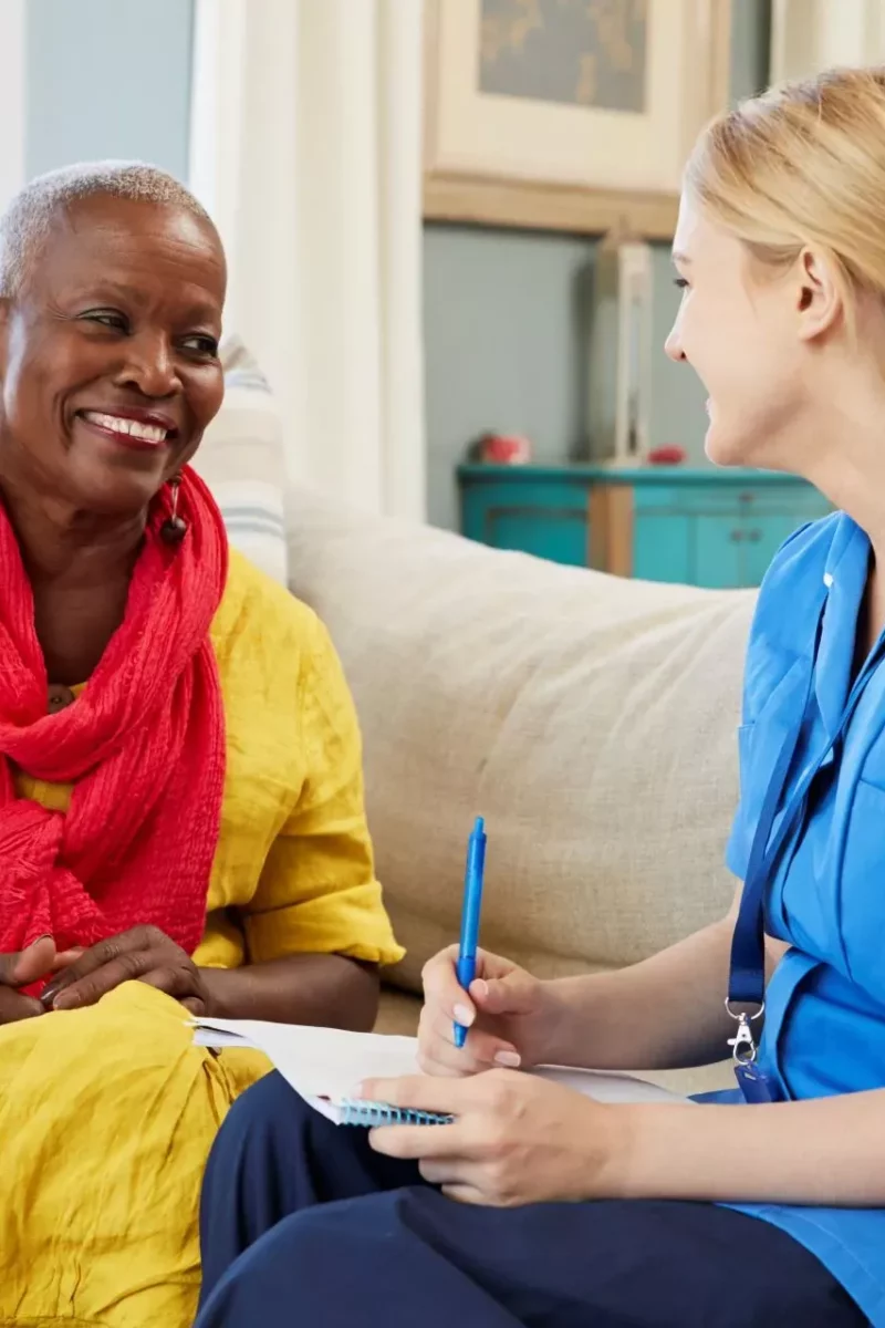 A pharmacist reviewing medicines with a patient at home