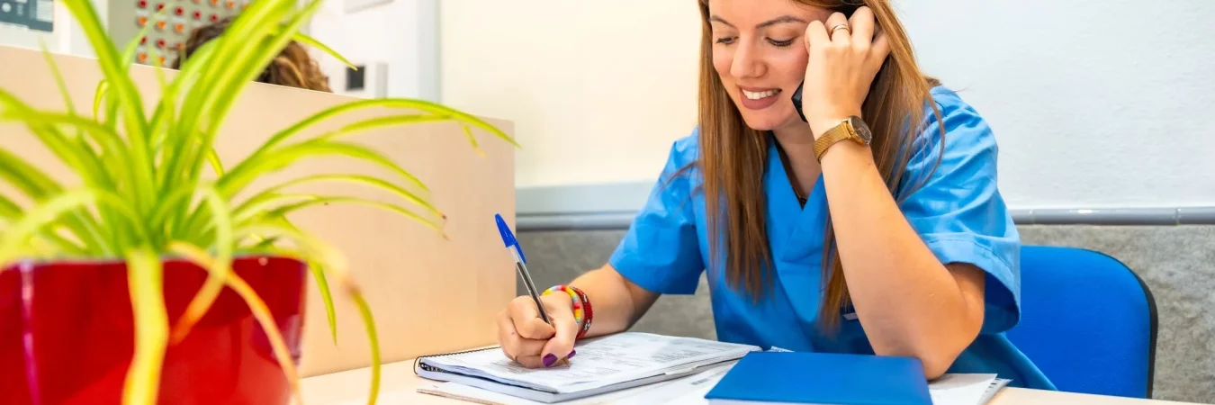 A nurse writing up paperwork