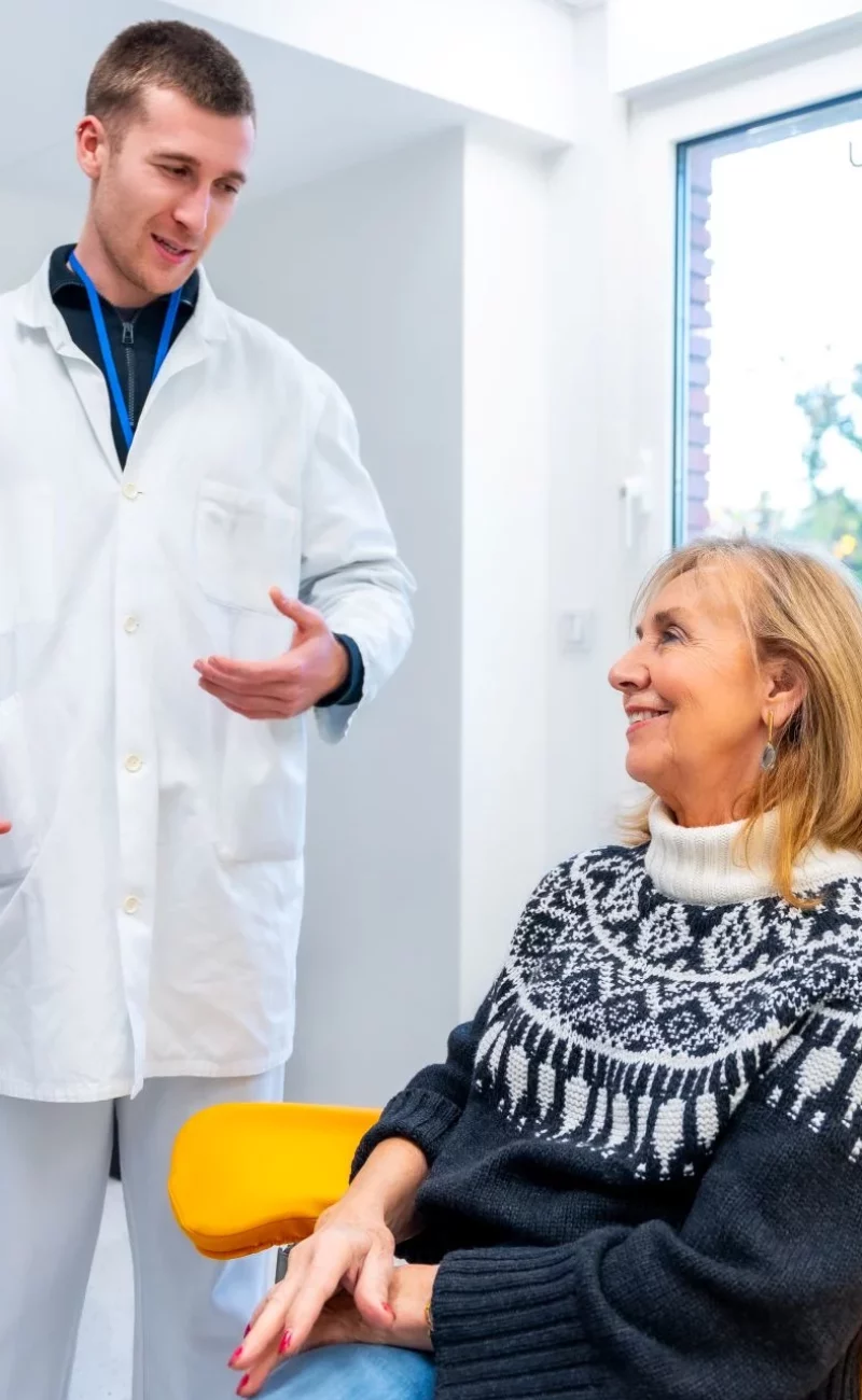 A nurse examining an elderly patient