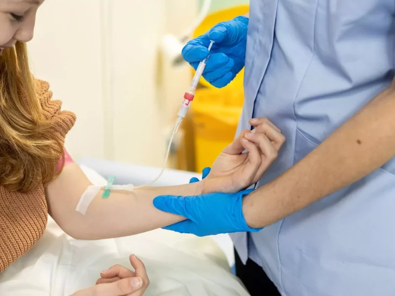 A nurse giving an injection to a young patient