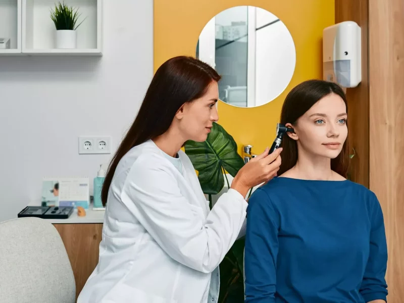 A clinician examining a patient’s ear