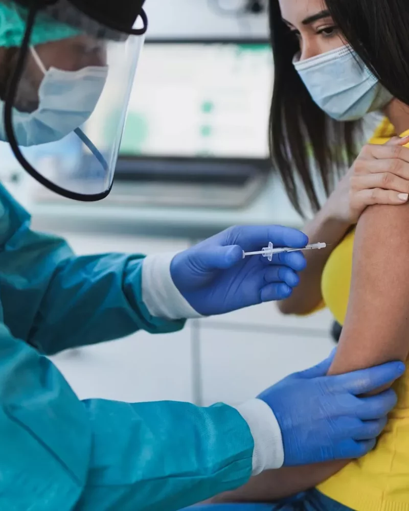 A nurse preparing a travel vaccination